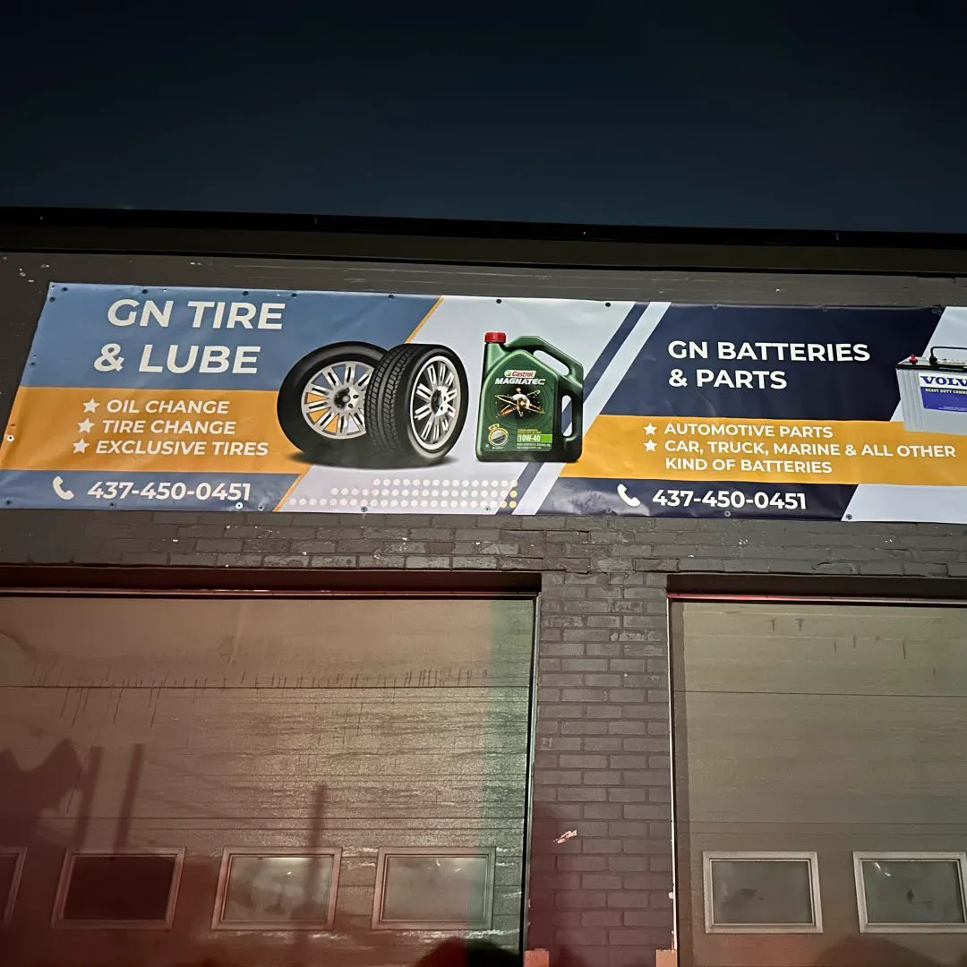 GN Tire & Lube and GN Batteries & Parts banner above the shop's bay doors